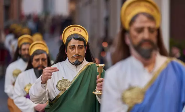Penitents depicting the apostles march during a Holy Week procession of the "Hermandad de Nuestro Padre Jesus Nazareno" brothergood in Puente Genil, southern Spain, Friday, April 3, 2026. (AP Photo/Manu Fernandez)