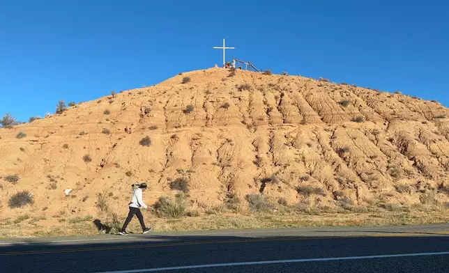 A pilgrim makes the Good Friday journey to Chimayó, New Mexico, on Friday, April 3, 2026. (AP Photo/Susan Montoya Bryan)