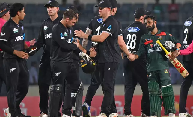 Bangladesh's captain Mehidy Hassan Miraz shake hand with New Zealand players, after winning the second one day international match against New Zealand, in Mirpur, Bangladesh, Monday, April 20, 2026. (AP Photo/Mosaraf Hossain)