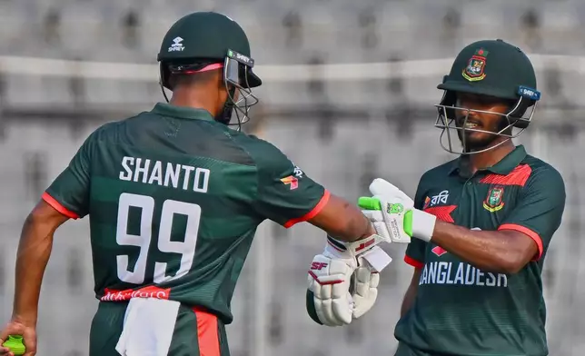 Bangladesh's Najmul Hossain Shanto congratulate Tanzid Hasan Tamim, right fir scoring fifty runs during the second one day international cricket match between Bangladesh and New Zealand in Mirpur, Bangladesh, Monday, April 20, 2026. (AP Photo/Mosaraf Hossain)
