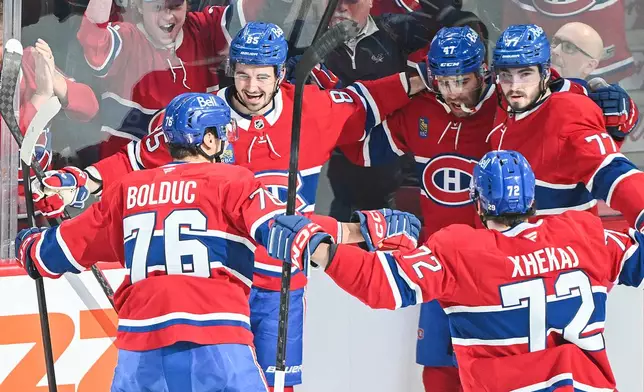 Montreal Canadiens' Alexandre Texier (85) celebrates with teammates after scoring against the Tampa Bay Lightning during the first period of Game 3 in a first-round NHL hockey Stanley Cup playoff series in Montreal, Friday, April 24, 2026. (Graham Hughes/The Canadian Press via AP)