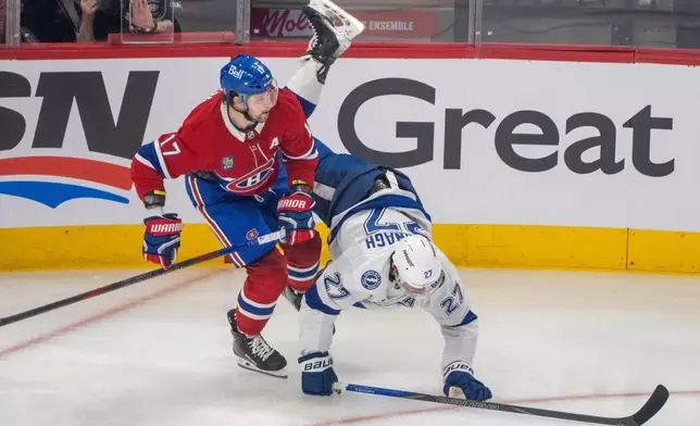 Tampa Bay Lightning's Ryan McDonagh (27) is upended by Montreal Canadiens' Josh Anderson (17) during the first period of Game 3 in a first-round NHL hockey Stanley Cup playoff series in Montreal, Friday, April 24, 2026. (Christinne Muschi/The Canadian Press via AP)