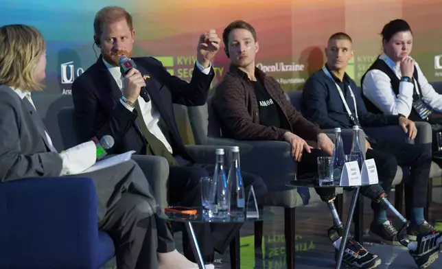 Britain's Prince Harry, second from left, speaks during a discussion together with Ukrainian war veterans at the Security Forum in Kyiv, Ukraine, on Thursday, April 23, 2026. (AP Photo/Evgeniy Maloletka)