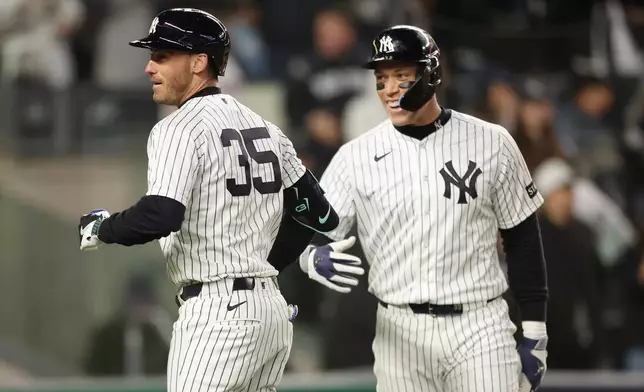 New York Yankees' Cody Bellinger (35) celebrates his two-run home run with Aaron Judge during the fifth inning of a baseball game against the Miami Marlins, Saturday, April 4, 2026, in New York. (AP Photo/Heather Khalifa)