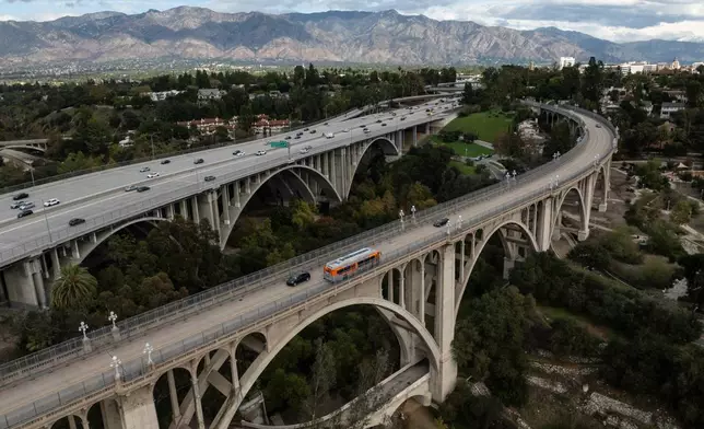 Motorists cross the historic Colorado Street Bridge in the foreground, a Route 66 landmark in Pasadena, Calif., Saturday, Nov. 22, 2025. (AP Photo/Jae C. Hong)