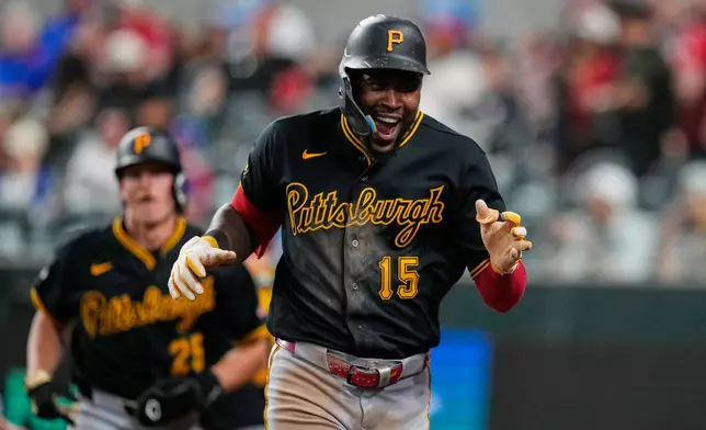 Pittsburgh Pirates' Oneil Cruz (15) celebrates after hitting a three-run home run in the ninth inning of a baseball game against the Texas Rangers Wednesday, April 22, 2026, in Arlington, Texas. (AP Photo/Tony Gutierrez)