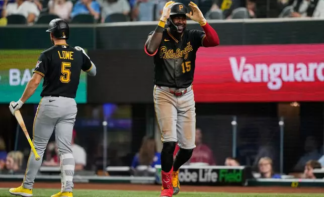Pittsburgh Pirates' Oneil Cruz celebrates his three-run home run with Brandon Lowe (5) in the ninth inning of a baseball game against the Texas Rangers Wednesday, April 22, 2026, in Arlington, Texas. (AP Photo/Tony Gutierrez)