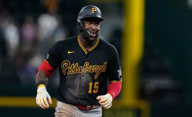 Pittsburgh Pirates' Oneil Cruz celebrates his three-run home run in the ninth inning of a baseball game against the Texas Rangers Wednesday, April 22, 2026, in Arlington, Texas. (AP Photo/Tony Gutierrez)