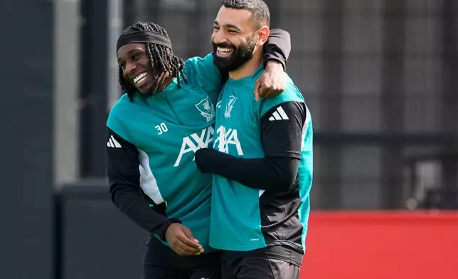 Liverpool's Mohamed Salah and Jeremie Frimpong, left, attend a training session in Liverpool, England, Tuesday April 7, 2026. (Peter Byrne/PA via AP)