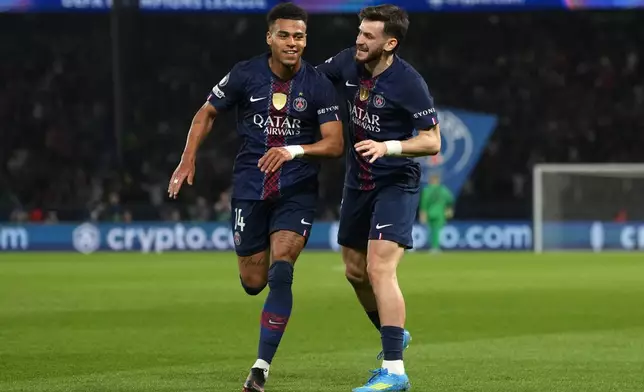 PSG's Desire Doue, left, celebrates with PSG's Khvicha Kvaratskhelia after scoring the opening goal during the Champions League quarterfinal first leg soccer match between Paris Saint-Germain and Liverpool in Paris, Wednesday, April 8, 2026. (AP Photo/Thibault Camus)