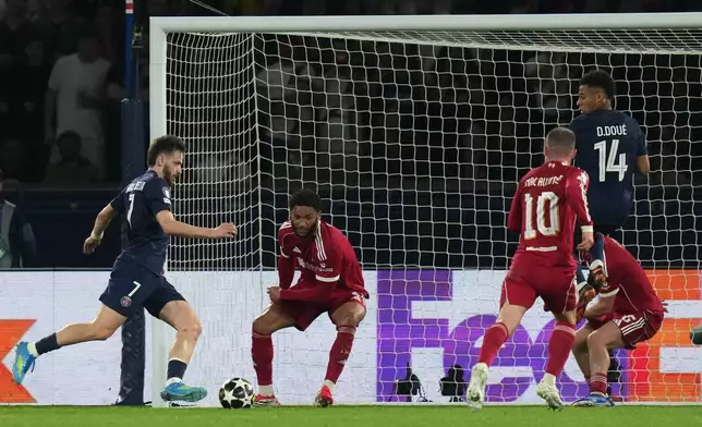 PSG's Khvicha Kvaratskhelia, left, scores his side's second goal during the Champions League quarterfinal first leg soccer match between Paris Saint-Germain and Liverpool in Paris, Wednesday, April 8, 2026. (AP Photo/Thibault Camus)