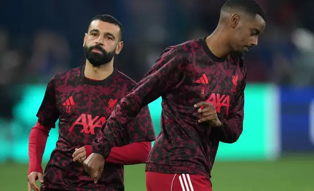 Liverpool's Alexander Isak, right, and Liverpool's Mohamed Salah run during the warm up before the Champions League quarterfinal first leg soccer match between Paris Saint-Germain and Liverpool in Paris, Wednesday, April 8, 2026. (AP Photo/Thibault Camus)