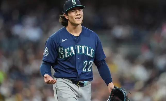 Seattle Mariners starting pitcher Bryan Woo reacts towards first base umpire Bill Miller after being called for a balk during the second inning of a baseball game against the San Diego Padres Tuesday, April 14, 2026, in San Diego. (AP Photo/Gregory Bull)