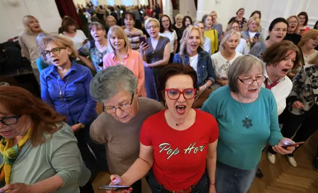 Choir members perform a song during a practice in Belgrade, Serbia, Wednesday, April 15, 2026. (AP Photo/Darko Vojinovic)