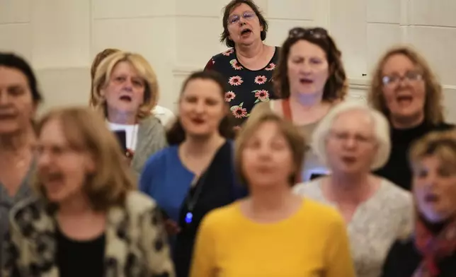 Choir members perform a song during a practice in Belgrade, Serbia, Wednesday, April 15, 2026. (AP Photo/Darko Vojinovic)