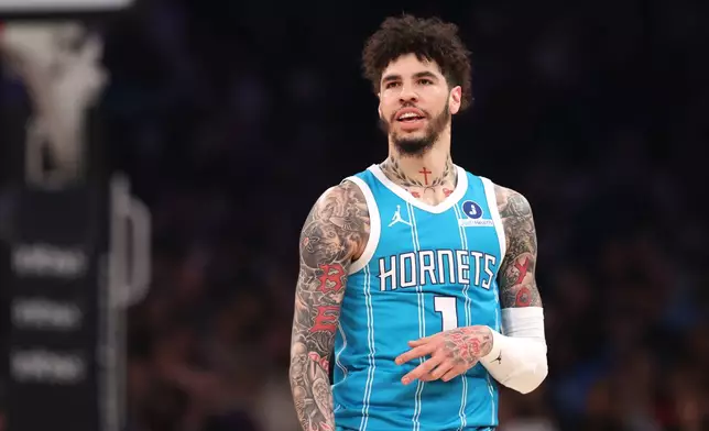 Charlotte Hornets' LaMelo Ball (1) reacts after scoring a three-point basket against the New York Knicks during the first half of an NBA basketball game, Sunday, April 12, 2026, in New York. (AP Photo/Pamela Smith)