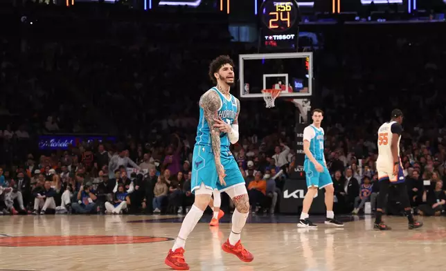 Charlotte Hornets' LaMelo Ball, center, reacts after scoring during the first half of an NBA basketball game against the New York Knicks, Sunday, April 12, 2026, in New York. (AP Photo/Pamela Smith)