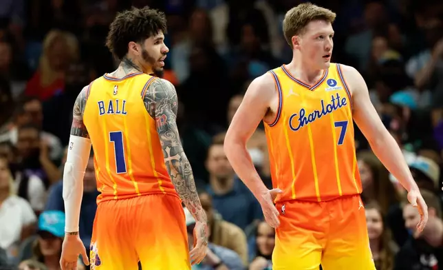 Charlotte Hornets guard LaMelo Ball (1) and guard Kon Knueppel (7) stand on the court during the first half of an NBA basketball game against the Detroit Pistons in Charlotte, N.C., Friday, April 10, 2026. (AP Photo/Nell Redmond)