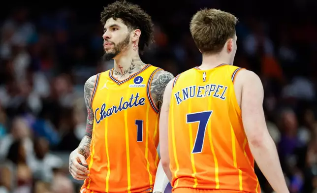 Charlotte Hornets guards LaMelo Ball (1) and Kon Knueppel stands on the court during the second half of an NBA basketball game against the Detroit Pistons in Charlotte, N.C., Friday, April 10, 2026. (AP Photo/Nell Redmond)