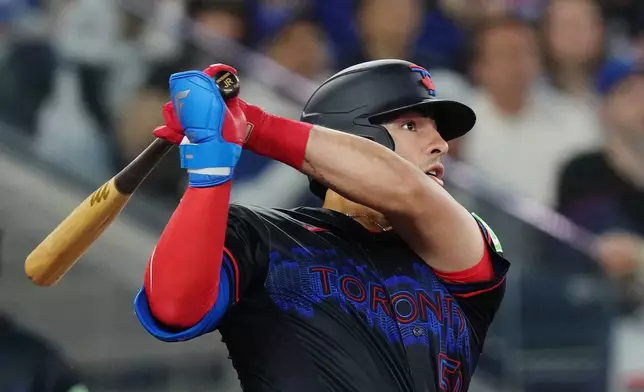 Toronto Blue Jays' Brandon Valenzuela (59) hits a two-run home run against the Minnesota Twins during fourth inning MLB baseball action in Toronto on Friday, April 10, 2026. (Chris Young/The Canadian Press via AP)
