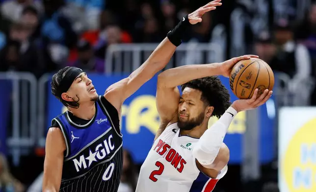 Orlando Magic guard Anthony Black (0) guards Detroit Pistons guard Cade Cunningham (2) during the second half in Game 5 of a first-round NBA basketball playoffs series Wednesday, April 29, 2026, in Detroit. (AP Photo/Duane Burleson)