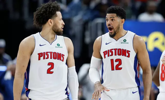 Detroit Pistons forward Tobias Harris (12) reads to a basket scored against the Orlando Magic by guard Cade Cunningham (2) during the second half in Game 5 of a first-round NBA basketball playoffs series Wednesday, April 29, 2026, in Detroit. (AP Photo/Duane Burleson)