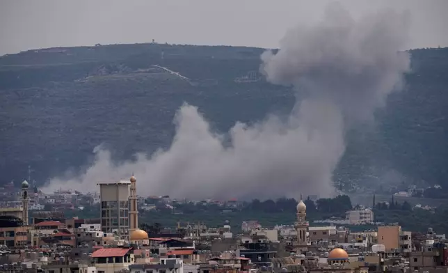 Smoke rises following an Israeli airstrike on the village of Qlaileh, as seen from the southern port city of Tyre, Lebanon, Wednesday, April 15, 2026. (AP Photo/Hussein Malla)