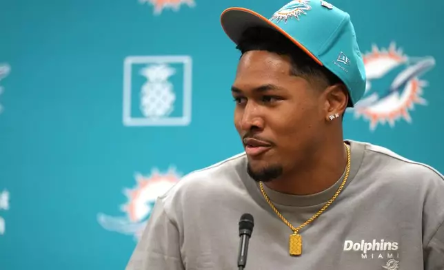 Miami Dolphins first-round draft pick Chris Johnson listens to questions from media during an NFL football news conference, Friday, April 24, 2026, in Miami Gardens, Fla. (AP Photo/Jim Rassol)