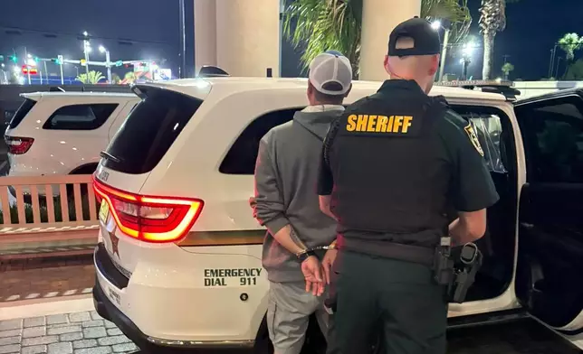 This photo provided by the Okaloosa County Sheriff's Office shows Christopher Gillum being arrested Wednesday, April 22, 2026, at a hotel in Destin, Fla. (Okaloosa County Sheriff's Office via AP)