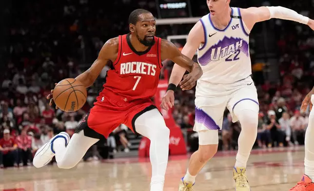 Houston Rockets forward Kevin Durant (7) controls the ball against Utah Jazz forward Kyle Filipowski (22) during the first half of an NBA basketball game, Friday, April 3, 2026, in Houston. (AP Photo/Karen Warren)