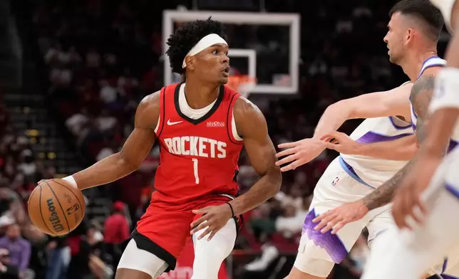 Houston Rockets guard Amen Thompson (1) controls the ball against the Utah Jazz during the first half of an NBA basketball game, Friday, April 3, 2026, in Houston. (AP Photo/Karen Warren)