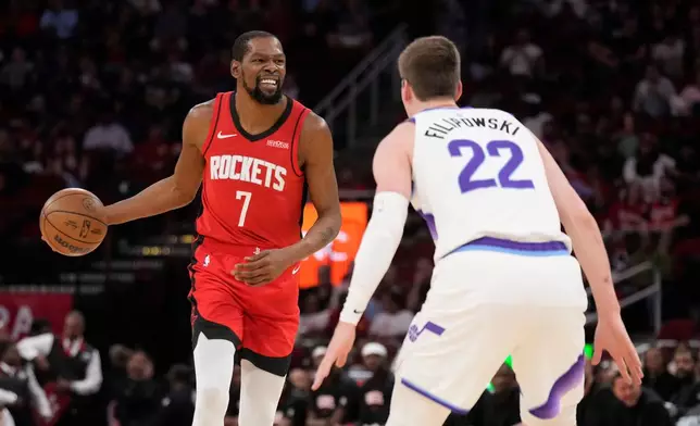 Houston Rockets forward Kevin Durant (7) controls the ball against Utah Jazz forward Kyle Filipowski (22) during the first half of an NBA basketball game, Friday, April 3, 2026, in Houston. (AP Photo/Karen Warren)