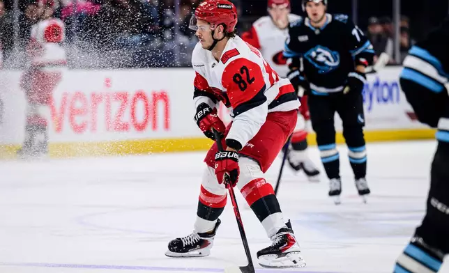 Carolina Hurricanes center Jesperi Kotkaniemi (82) skates with the puck during the first period of an NHL hockey game against the Utah Mammoth, Saturday, April 11, 2026, in Salt Lake City. (AP Photo/Tyler Tate)
