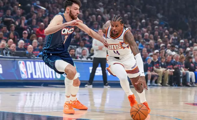 Phoenix Suns guard Jalen Green (4) drives past Oklahoma City Thunder center Chet Holmgren (7) during the first half in Game 2 of a first-round NBA playoffs basketball series Wednesday, April 22, 2026, in Oklahoma City. (AP Photo/Kyle Phillips)