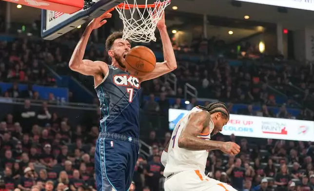 Oklahoma City Thunder center Chet Holmgren, left, dunks over Phoenix Suns guard Jalen Green during the second half in Game 2 of a first-round NBA playoffs basketball series Wednesday, April 22, 2026, in Oklahoma City. (AP Photo/Kyle Phillips)
