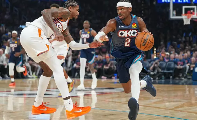 Oklahoma City Thunder guard Shai Gilgeous-Alexander, right, drives past Phoenix Suns guard Jalen Green during the second half in Game 2 of a first-round NBA playoffs basketball series Wednesday, April 22, 2026, in Oklahoma City. (AP Photo/Kyle Phillips)
