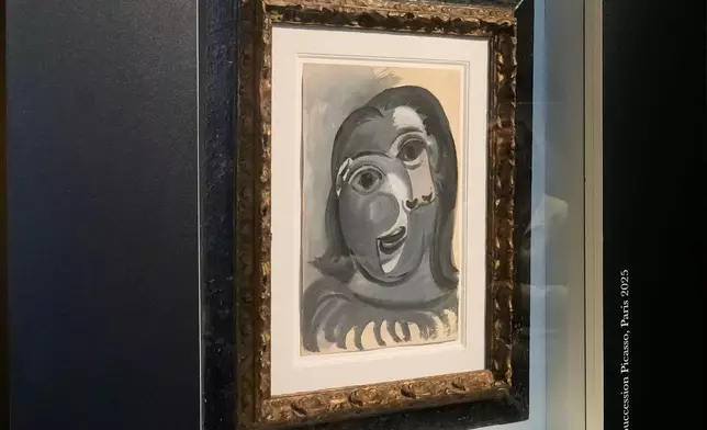 The Head of a Woman by Pablo Picasso, painted in 1941, is presented in Paris, Friday, April 10, 2026, where the draw will be handled by auction house Christie's next week. (AP Photo/Michel Euler)
