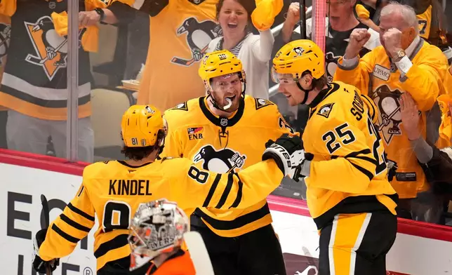 Pittsburgh Penguins' Elmer Soderblom (25) celebrates with Ben Kindel (81) and Anthony Mantha (39) after scoring against the Philadelphia Flyers during the first period of Game 5 in the first round of an NHL hockey Stanley Cup playoff series in Pittsburgh, Monday, April 27, 2026. (AP Photo/Gene J. Puskar)