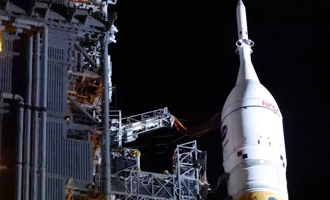 FILE - The NASA Artemis II rocket, with the Orion spacecraft aboard, leaves the Vehicle Assembly Building at the Kennedy Space Center in Cape Canaveral, Fla., March 20, 2026. (AP Photo/Terry Renna, File)