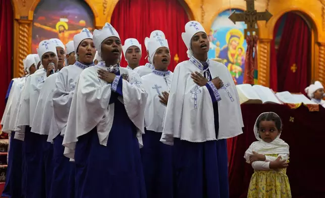 A Sunday school group performs a hymn during Good Friday service at Re'ese Adbarat Debre Selam Kidist Mariam Church, an Ethiopian Orthodox Tewahedo church, in Washington, Friday, April 10, 2026. (AP Photo/Jessie Wardarski)