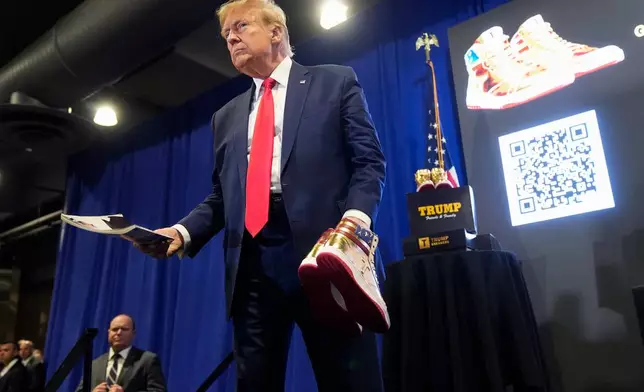 FILE - Donald Trump hold a Playboy magazine and gold Trump sneakers at Sneaker Con Philadelphia, an event popular among sneaker collectors, in Philadelphia, Saturday, Feb. 17, 2024. (AP Photo/Manuel Balce Ceneta, File)