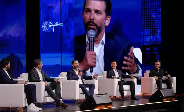 FILE - From left, moderator Aaron Arnold, Eric Trump, Donald Trump Jr., Mike Ho, executive chairman of American Bitcoin and Matt Prusak, CEO of American Bitcoin, sit on stage at Bitcoin 2025, Wednesday, May 28, 2025, in Las Vegas. (AP Photo/John Locher, File)