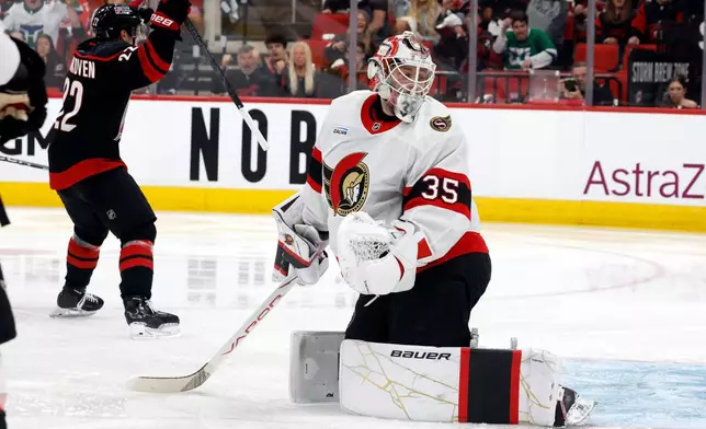 Ottawa Senators goaltender Linus Ullmark (35) looks past toward the net as Carolina Hurricanes' Logan Stankoven (22) celebrates his goal during the second period of an Game 1 of an NHL hockey Stanley Cup first-round playoff series in Raleigh, N.C., Saturday, April 18, 2026. (AP Photo/Karl DeBlaker)