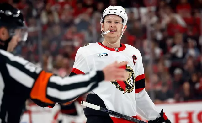 Ottawa Senators' Brady Tkachuk, right, protests a call with an official during the second period of an Game 1 of an NHL hockey Stanley Cup first-round playoff series against the Carolina Hurricanes in Raleigh, N.C., Saturday, April 18, 2026. (AP Photo/Karl DeBlaker)