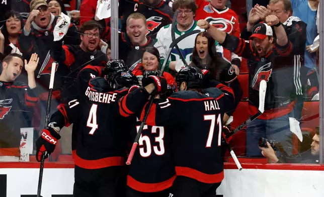 Carolina Hurricanes celebrate a goal by Logan Stankoven (22) during the second period of an Game 1 of an NHL hockey Stanley Cup first-round playoff series against the Ottawa Senators in Raleigh, N.C., Saturday, April 18, 2026. (AP Photo/Karl DeBlaker)