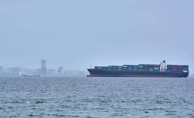 A container ship is seen in the Strait of Hormuz off the coast of Qeshm Island, Iran, Saturday, April 18, 2026. (AP Photo/Asghar Besharati)
