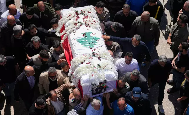 Mourners carry the coffin of Lebanese journalist Amal Khalil, who was killed Wednesday in an Israeli airstrike, during her funeral procession in the village of Baysariyeh in southern Lebanon on Thursday, April 23, 2026. (AP Photo/Mohammed Zaatari)