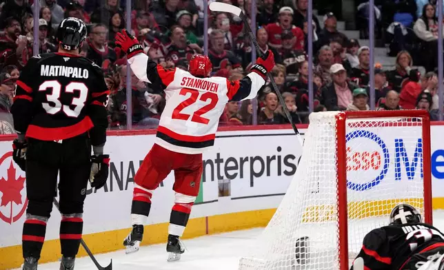 Carolina Hurricanes' Logan Stankoven (22) celebrates scoring on Ottawa Senators goaltender Linus Ullmark (35) during the third period in Game 4 of a first-round NHL Stanley Cup playoff hockey series, Saturday, April 25, 2026, in Ottawa, Ontario. (Justin Tang/The Canadian Press via AP)