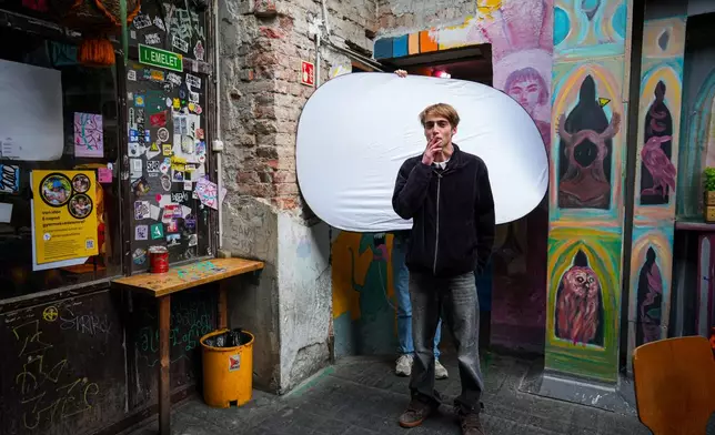 Gusztav Komaromy, 22, poses for a portrait as he smokes a cigarette in Budapest, Hungary, Monday, April 13, 2026. "We had a regime that took control of our lives and political consciousness. We had to take a stance about propaganda, about political cynicism, about the state of the public sphere. " (AP Photo/Petr David Josek)