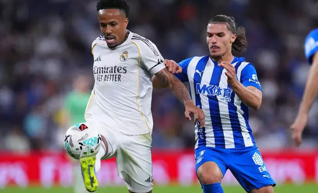 Real Madrid's Eder Militao, in action in front of Alaves' Youssef Enriquez during a La Liga soccer match between Real Madrid and Alaves in Madrid, Spain, Tuesday, April 21, 2026. (AP Photo/Manu Fernandez)